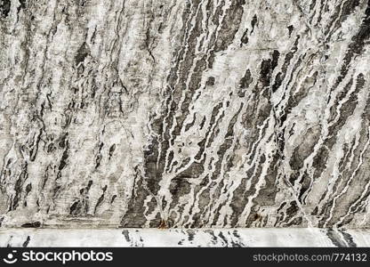 A view underneath a bridge overpass near Marginal Way in Seattle shows a pattern from efflorescence of lime that leaches out of the concrete.