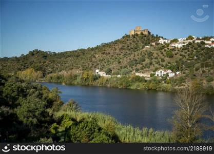 a view with the Castelo de Belver with the Town of Belver at the Rio Tejo in Alentejo in  Portugal.  Portugal, Belver, October, 2021