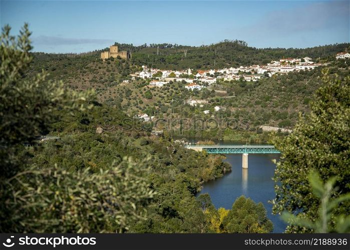 a view with the Castelo de Belver with the Town of Belver at the Rio Tejo in Alentejo in Portugal. Portugal, Belver, October, 2021