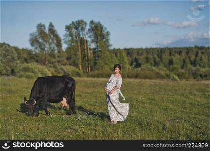 A village girl near a grazing cow.. Portrait of a girl in a closed dress standing near a cow in a meadow 1757.