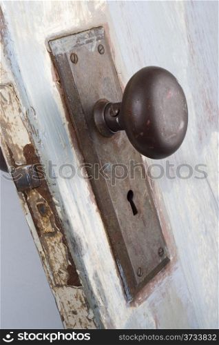 A vintage and worn door, handle and keyhole