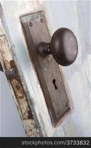 A vintage and worn door, handle and keyhole