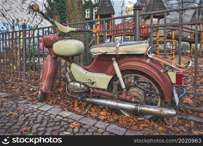 A vintage motorcycle next to a railing
