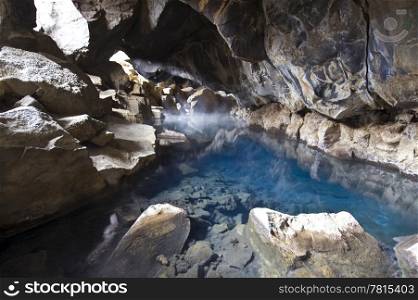 A volcanically formed cave, housing a geothermal hot water spring in the Myvatn area, North Iceland
