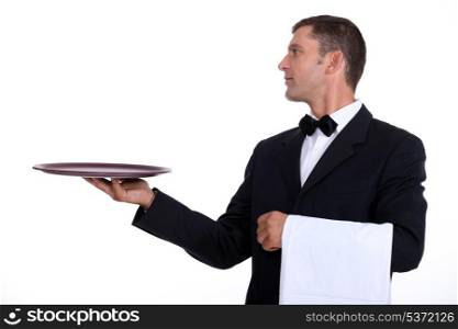 A waiter holding an empty tray