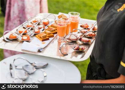 A waiter serving snack in a cocktail for the celebration of a party. No faces