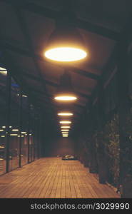 A walk in front of a cafe decorated with old vintage lamps.