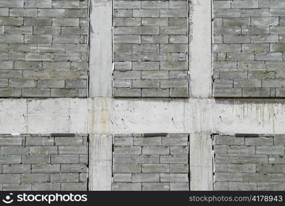 A wall of textured gray construction bricks.