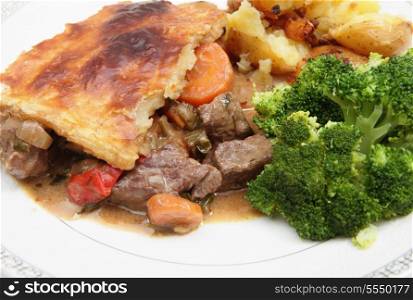 A warming homemade steak and vegetable pie, served with crushed sauteed garlic potatoes and broccoli