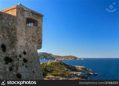 A watchtower in the citadel at Calvi overlooking the Mediterranean and the lighthouse at La Revellata