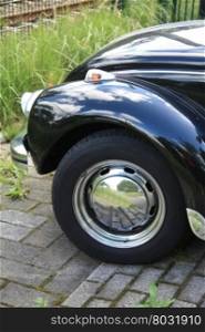 A wheel of a vintage black car