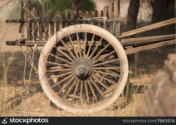 a wheel of a woodcart of a farmer stays on a field in Bagan in Myanmar in Southeastasia.. ASIA MYANMAR BAGAN AGRACULTURE WAGON