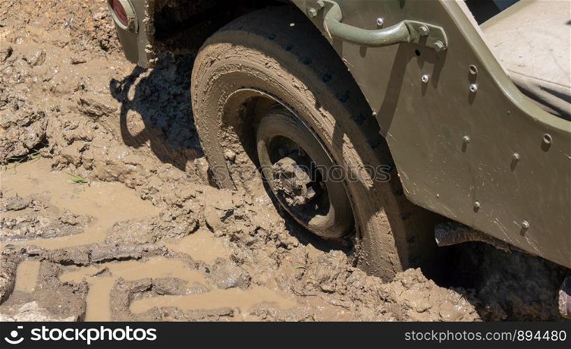 a wheel of military vehicle in the mud