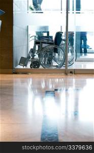 A wheelchair in a reception area of a hotel or hospital
