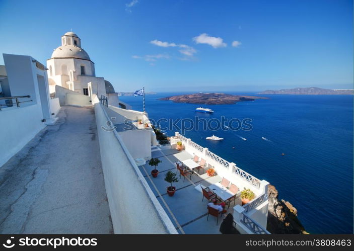 A white church in Fira on Santorini island, Greece. Traditional architecture over the Caldera, Aegean sea