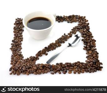 a white coffee cup with spoon and coffee beans