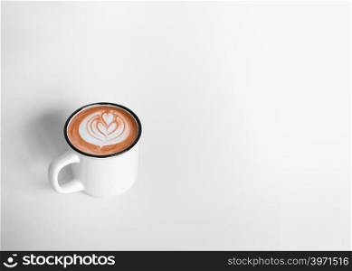 A white cup of hot coffee latte art on white background with copy space or space for text, design for wide banner, poster, postcard, Top view.