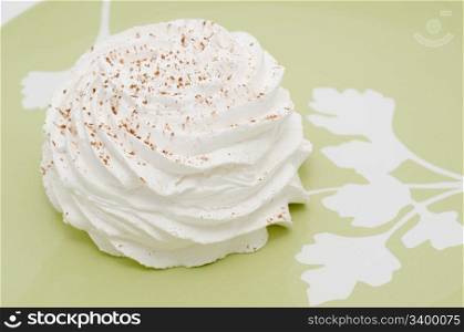 a white meringue dusted with cocoa powder