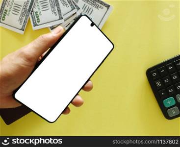 A white screen smartphone with a top $ 100 bank note and a yellow background calculator