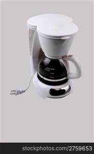 A white small four cup coffeemaker, with coffee in, for light graybackground.