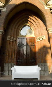 A white sofa outside a church