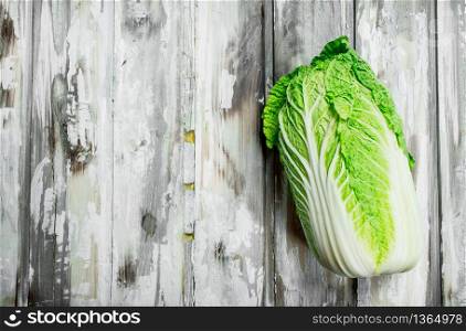 A whole cabbage. On a wooden background.. A whole cabbage.