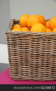 a wicker basket filled with juicy oranges