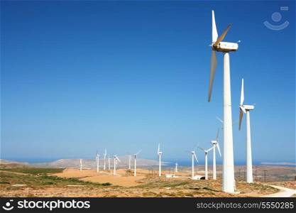 A wind farm snaking its way across the barren landscape in the hills of eastern Crete