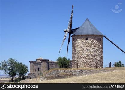 A windmill near the medieval castle of Belmonte. La Mancha region of central Spain.