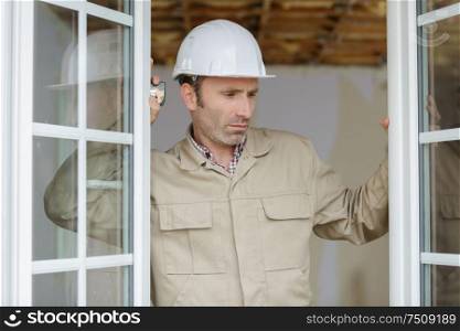 a window fitter checking installation