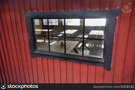 A window surrounded by wooden planks near Pampas Marine, Sweden