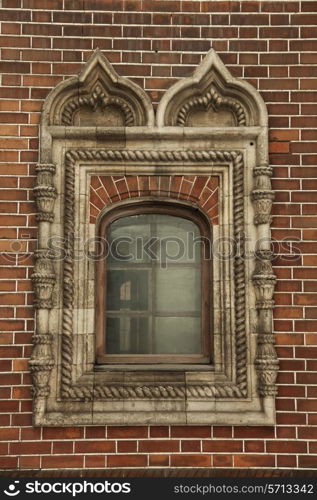 A window with ornament in the brick wall