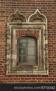 A window with ornament in the brick wall