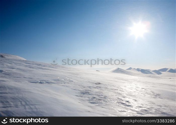 A winter landscape with blowing snow on Spitsbergen Island, Svalbard, Norway