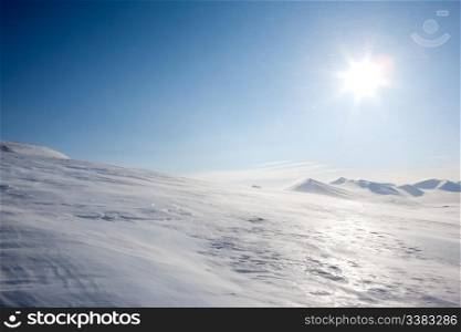 A winter landscape with blowing snow on Spitsbergen Island, Svalbard, Norway