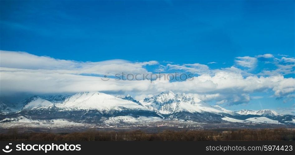 A winter panorama of Slovakia High Tatras on the background of the cloudy blue sky