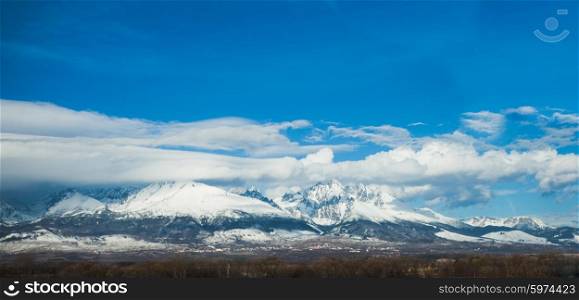 A winter panorama of Slovakia High Tatras on the background of the cloudy blue sky