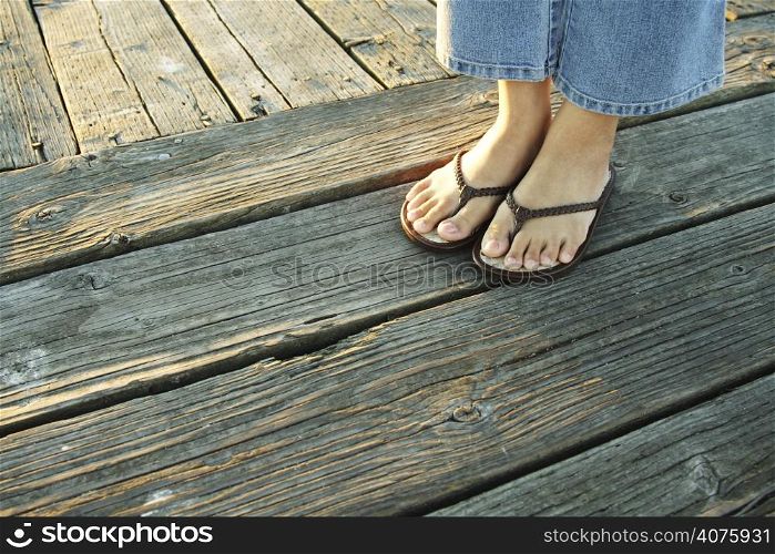 A woman&acute;s feet on a boardwalk