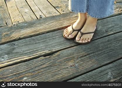 A woman&acute;s feet on a boardwalk