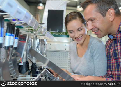 a woman and man at an utensil shop