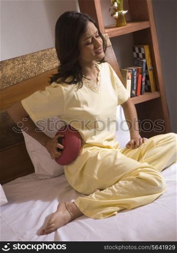 A woman applying a hot water bag