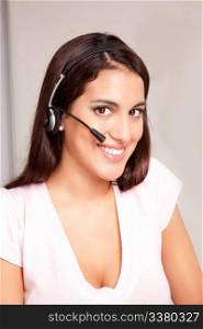 A woman at a call center smiling at the camera