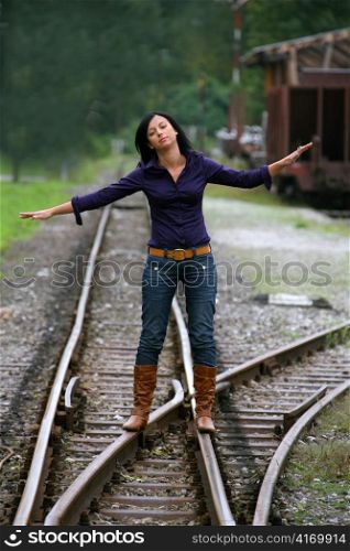 a woman at a railroad switch. decision for the future