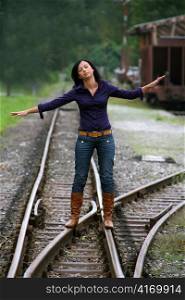 a woman at a railroad switch. decision for the future