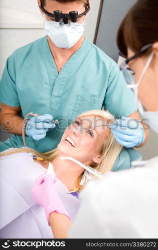 A woman at the dentist about to have some drilling done