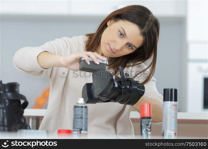 a woman brushing the shoe