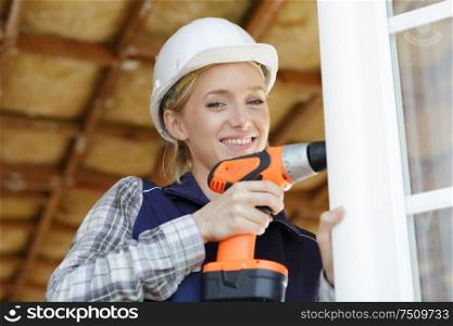 a woman builder using drill