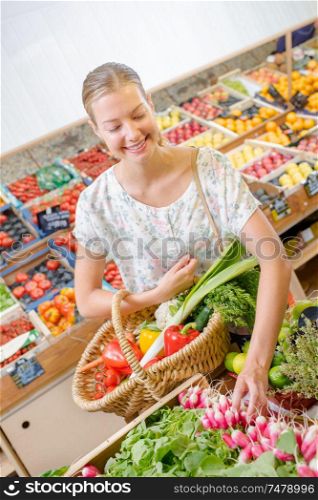 a woman buying some radishes