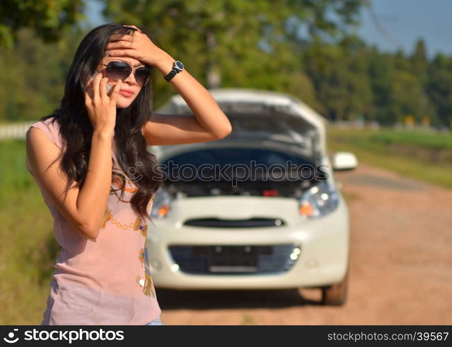 A woman calls for assistance after her car broke down