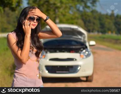 A woman calls for assistance after her car broke down